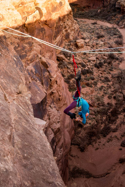 istock Female Extreme Athlete Highlining or Slacklining near Moab Utah 949565936