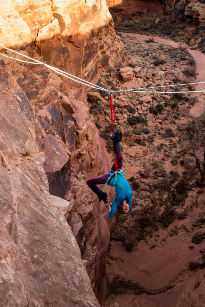 istock Female Extreme Athlete Highlining or Slacklining near Moab Utah 949565938
