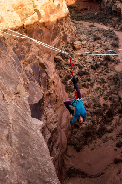 istock Female Extreme Athlete Highlining or Slacklining near Moab Utah 949565942
