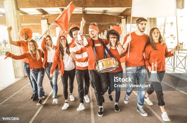 Football Supporter Fans Friends Cheering And Walking To Soccer Cup Match At Intenational Stadium Young People Group With Red And White Tshirts Having Excited Fun On Sport World Championship Concept Stock Photo - Download Image Now
