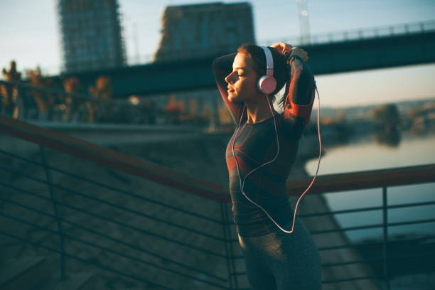 istock Young attractive female  runner taking break after jogging outdoors 949573044