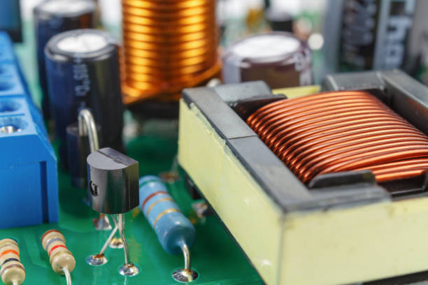 istock Transformer and electronic components installed on a printed circuit board closeup 949573278