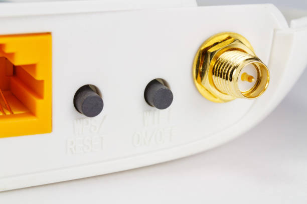 istock Antenna connector and control buttons on the back panel of the router closeup 949574732