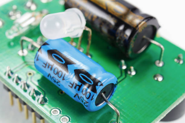 electrolytic capacitors and led diode on a printed circuit board - service electronics industry circuit board capacitor imagens e fotografias de stock