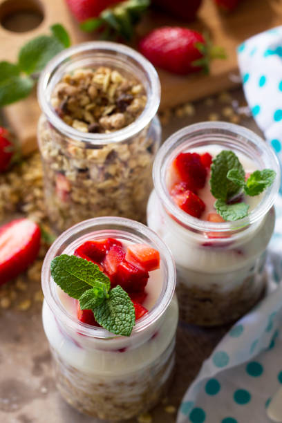 Homemade healthy breakfast with homemade baked granola, fresh strawberry and yogurt close-up on stone or concrete table. Homemade healthy breakfast with homemade baked granola, fresh strawberry and yogurt close-up on stone or concrete table. 11189 stock pictures, royalty-free photos & images