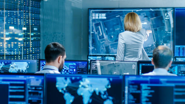 istock In the Government Surveillance Facility Team of Officers Organize Interception Plan with Help of Satellite Navigation. Big Screen Shows Top Down Images of the Target. 949581030