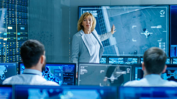 istock In the Government Surveillance Facility Team of Officers Organize Interception Plan with Help of Satellite Navigation. Big Screen Shows Top Down Images of the Target's Car. 949581064