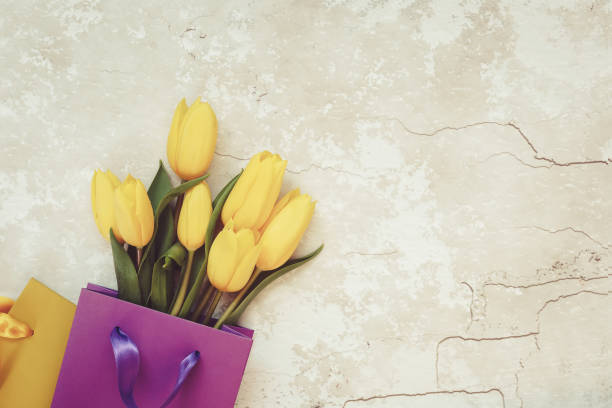 istock Yellow tulips in gift paper bag 949594944