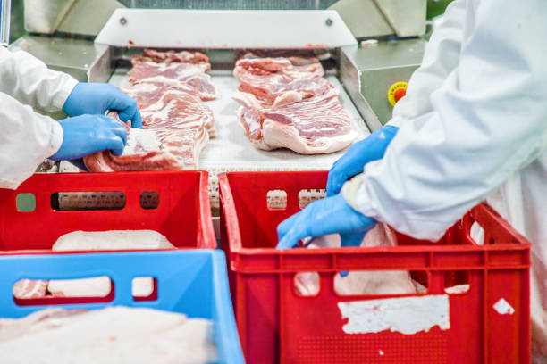 istock Butcher carving pork carcasses 949595698