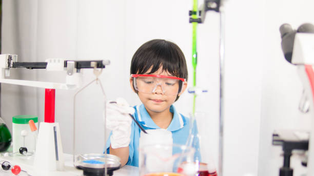 istock Happy kid child girl on playing and learning science laboratory 949596076