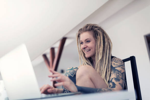 Young woman checking emails with laptop at home