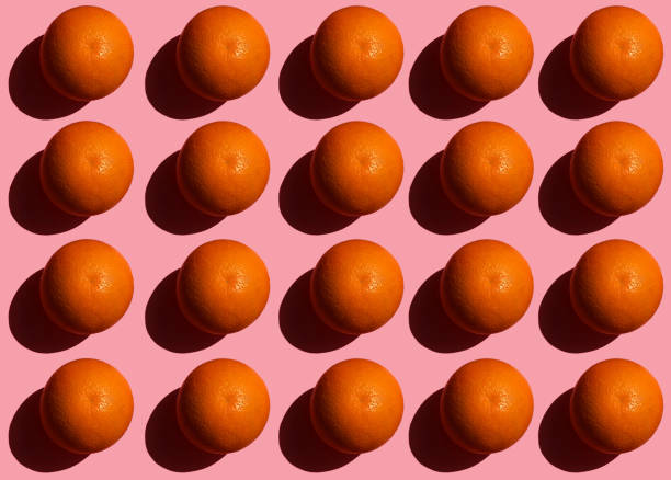 istock Colorful fruit pattern of fresh orange on pink background 949596434
