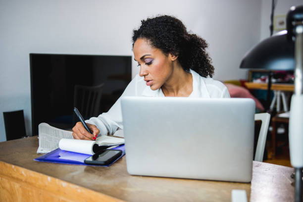 istock African American woman working at home using laptop 949603934