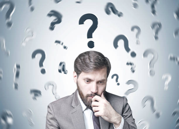 istock Bearded businessman in doubt, many questions 949606984