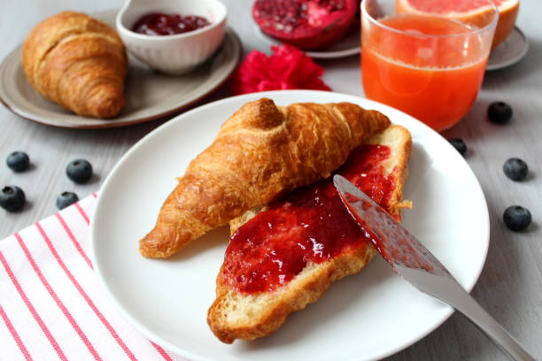 colazione con succo d'arancia e brioches. - preserves croissant breakfast food foto e immagini stock