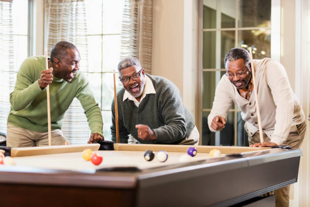 istock Three African-American men playing billiards 949614416