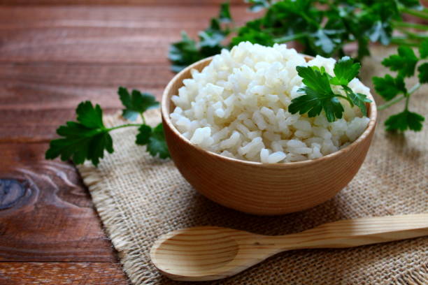 istock White rice in wooden bowl. 949615660
