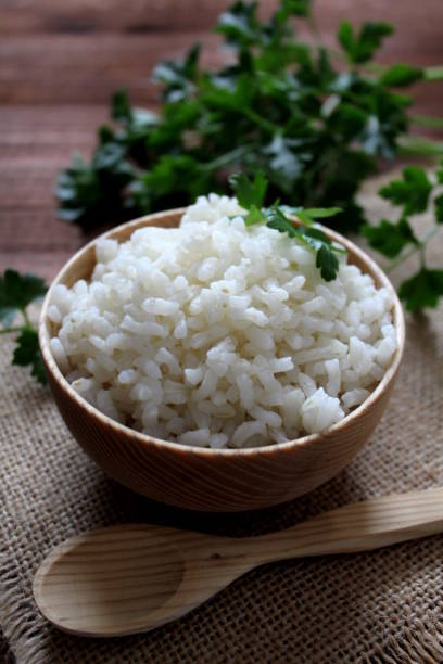 istock White rice in wooden bowl. 949615690