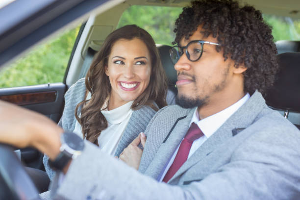 istock Happy young couple driving in a car while smiling 949615958