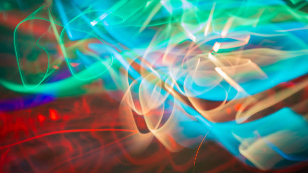 istock Wavy multicolored glowing lines against a dark background (long exposure shot) camera moving effect 949618658