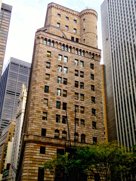 The Federal Reserve Building in downtown New York City in the summer as seen from the sidewalk.