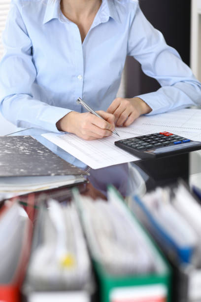 istock Female bookkeeper or financial inspector  making report, calculating or checking balance. Internal Revenue Service checking financial document. Audit concept in busines 949619658