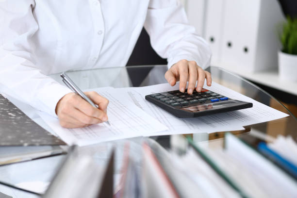 istock Female bookkeeper or financial inspector  making report, calculating or checking balance. Internal Revenue Service checking financial document. Audit concept in busines 949619880