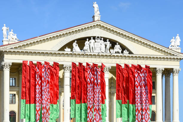 State flags of the Republic of Belarus against the backdrop of the Palace of Culture of Trade Unions in Minsk State flags of the Republic of Belarus against the backdrop of the Palace of Culture of Trade Unions in Minsk belarus stock pictures, royalty-free photos & images
