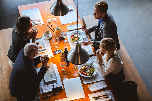 istock Group of Friends Having a Conversation During Lunch Time in a High-End Restaurant 949630328