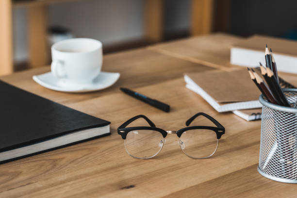istock Close-up view of glasses on office table with stationery 949630516