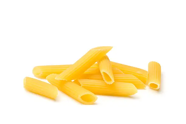 small heap of penne rigate isolated on white. See more here: