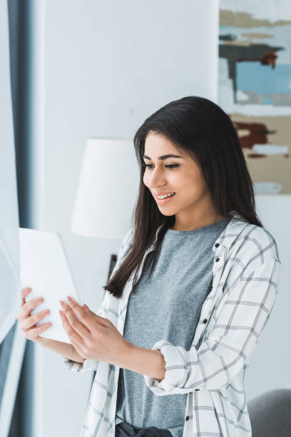 istock Pretty woman looking at digital tablet screen 949635688