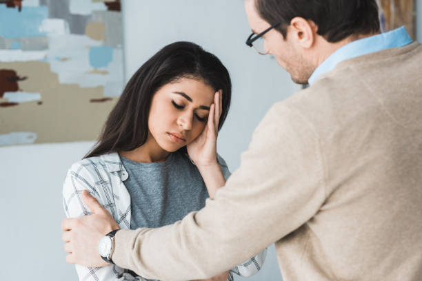 istock Therapist supporting his upset female patient 949636074