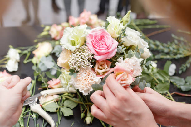 istock Master class on making bouquets for kids. Spring bouquet in metal ornamental flowerpot. Learning flower arranging, making beautiful bouquets with your own hands 949636180