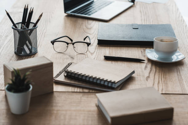 istock Business office workplace with laptop and notepads on table 949638594