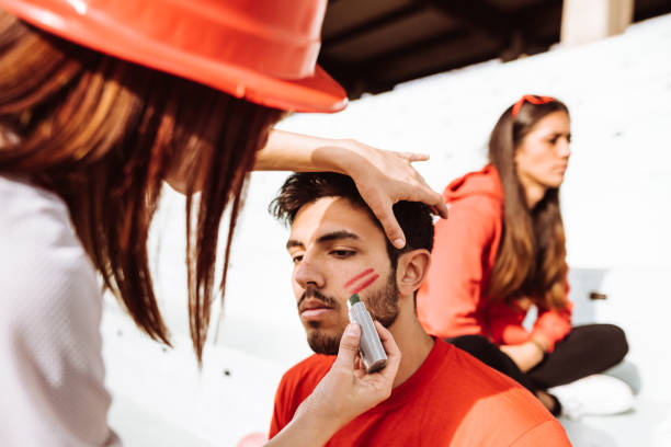istock painting the face of a supporter 949653032