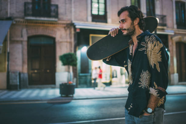 istock Man with skateboard on the street 949660774