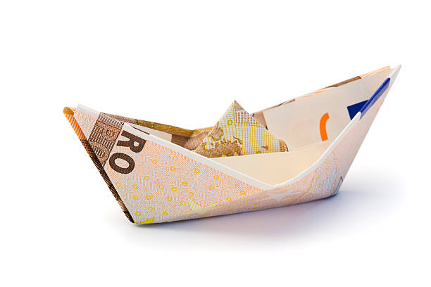 Swiss franc folded as boat over white background with reflection