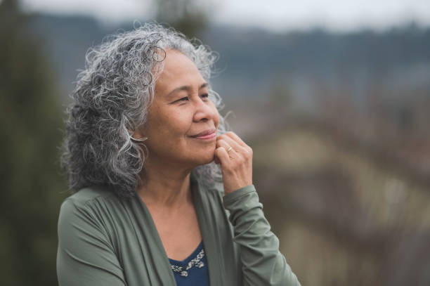 istock Senior ethnic woman practicing yoga outside on her back deck 949681234