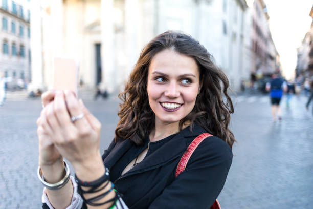 istock Young woman enjoying vacations and taking selfie 949691962