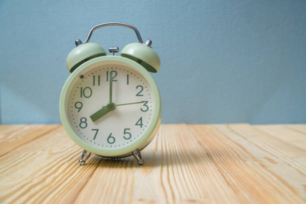 istock Retro vintage alarm clock on wood table, time concept. 949692012