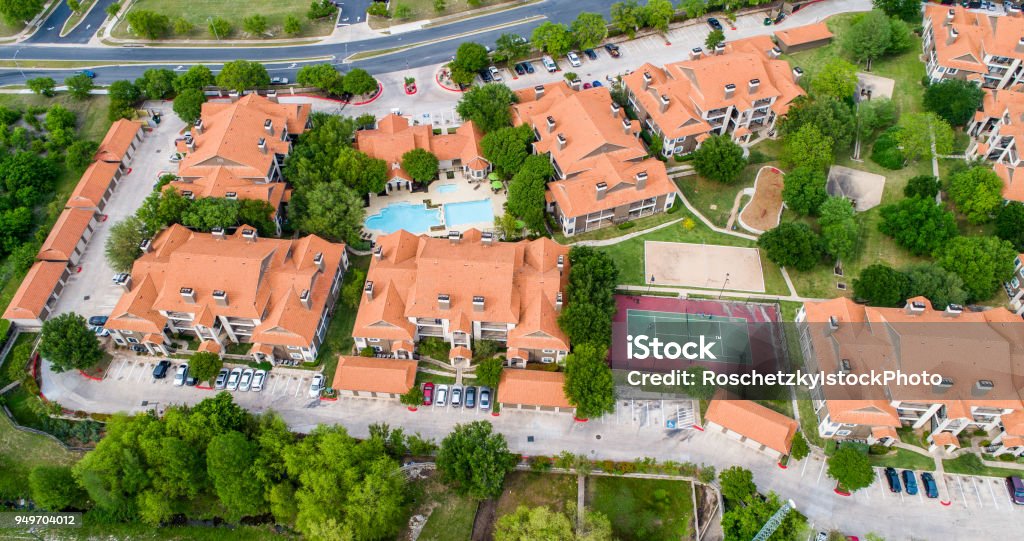 Orange townhomes high above entire apartment complex view Aerial drone view Orange townhomes high above entire apartment complex view - Austin , Texas , USA - with tennis court , swimming pool Retirement Community Stock Photo
