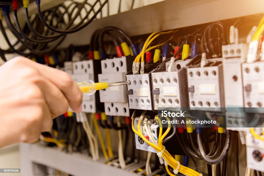 Electrician measurements with multimeter tester System ready. Electricity Stock Photo