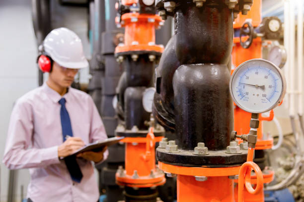 istock Engineer checking Condenser Water pump and pressure gauge , chiller water pump with pressure gauge.System ready. 949711558