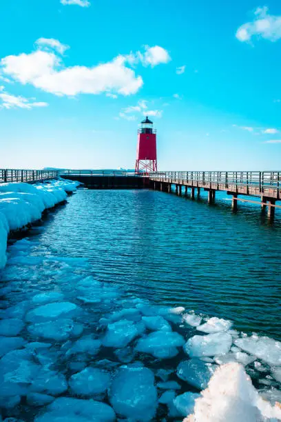 Lake Michigan thawing out after a long winter at the South Pier Lighthouse in Charlevoix, Michigan