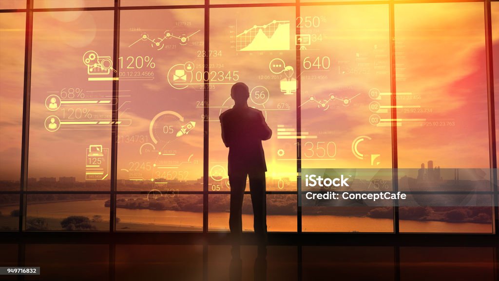 Corporate infographics and men in the office Silhouette of a man in a huge office in front of large windows viewing corporate infographics. CEO Stock Photo