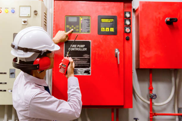 Engineer checking Industrial fire control system,Fire Alarm controller, Fire notifier, Anti fire.System ready In the event of a fire. stock photo