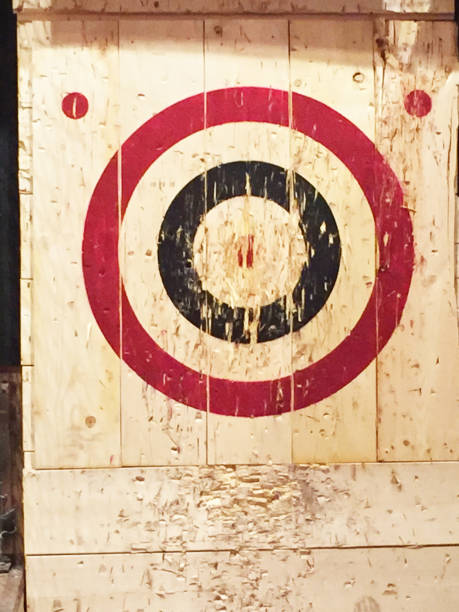 Wooden Targets A red and blue circle make a target on a wooden backdrop. axe throwing stock pictures, royalty-free photos & images