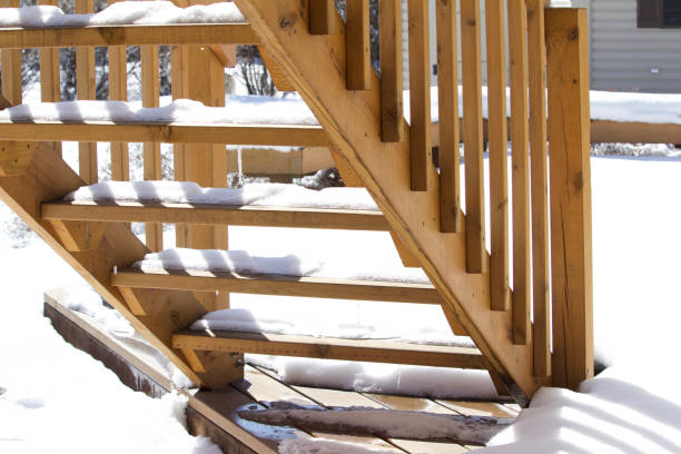 istock View of melting snow on a cedar deck staircase in early spring. 949734670