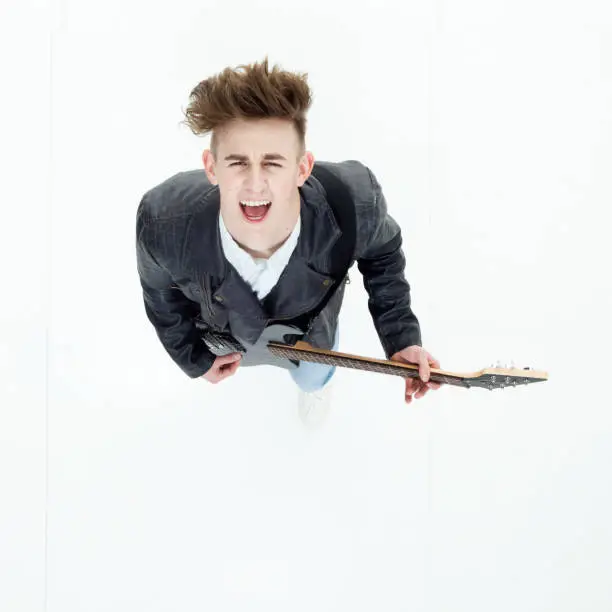Photo of Directly above view of young man playing an electric guitar
